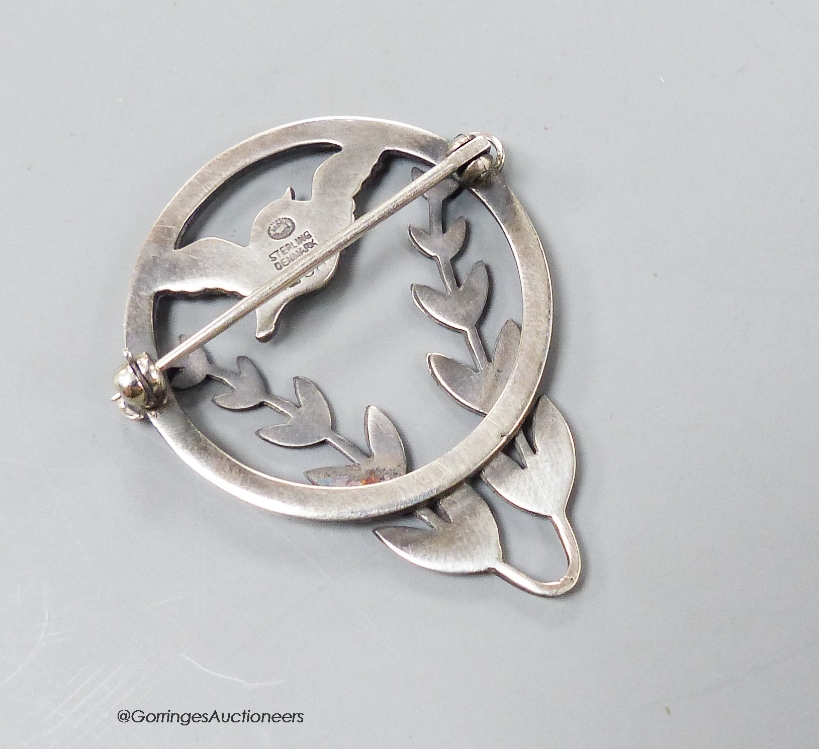 A Georg Jensen sterling circular framed 'bird amid foliage' brooch, designed by Arno Malinowski, no.258, 41mm